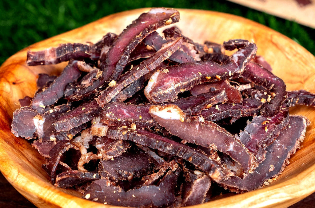 Slices of premium artisan South African Biltong displayed on a rustic board
